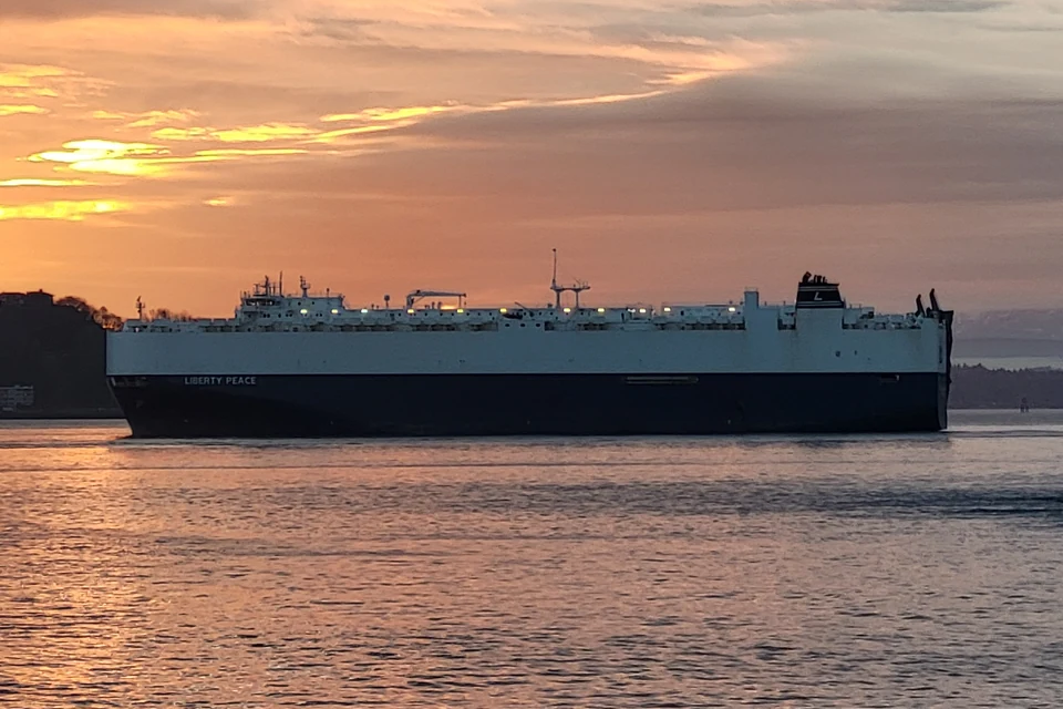 Car carrier vessel LIBERTY PEACE sailing at sunset.